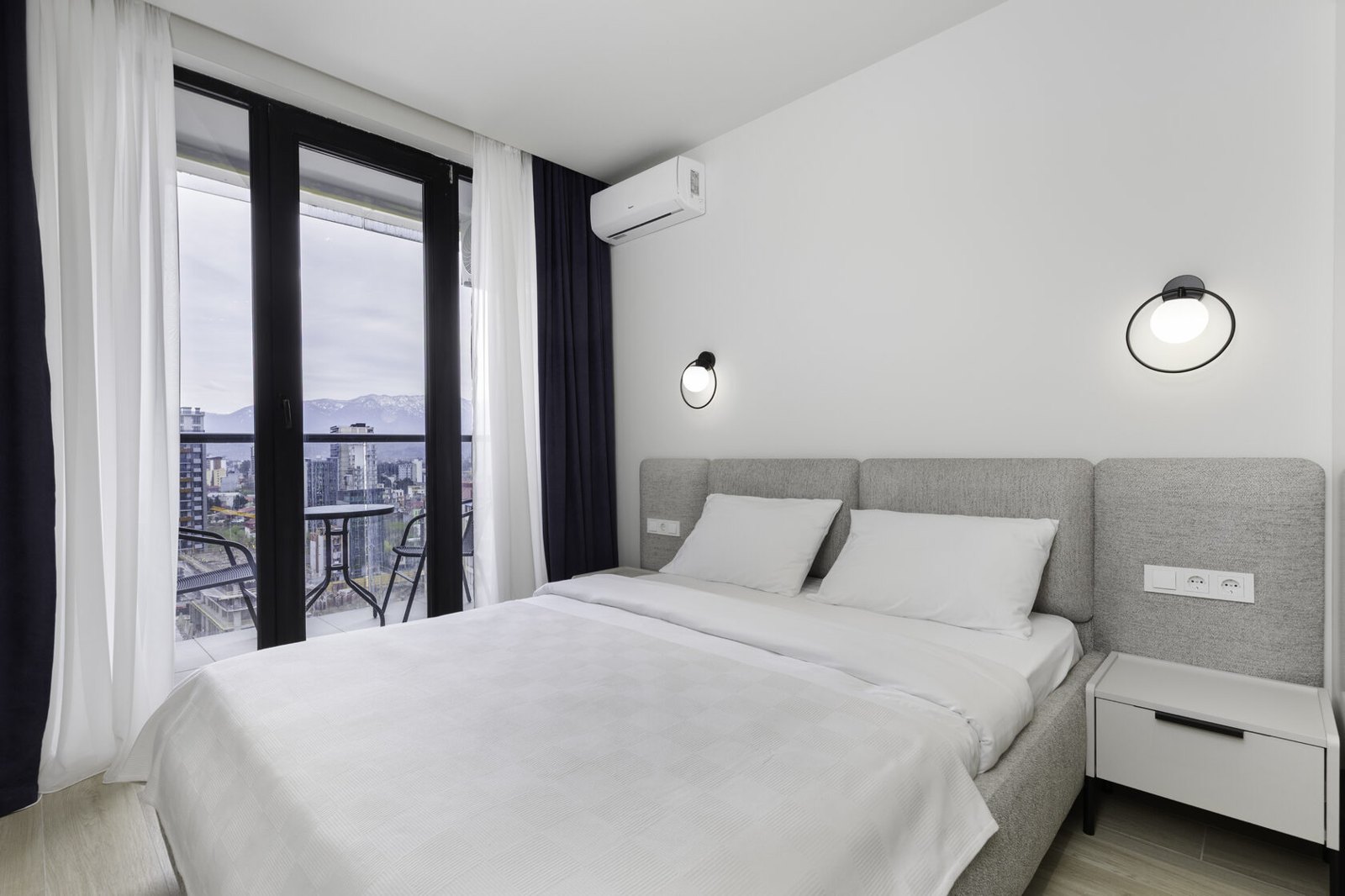 Guest bedroom at NEXT Apartments with a private balcony