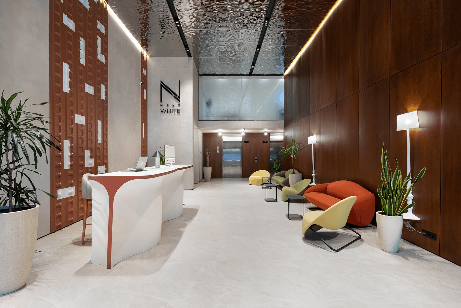 Completed NEXT White lobby with sculptural reception desk and colourful lounge seating