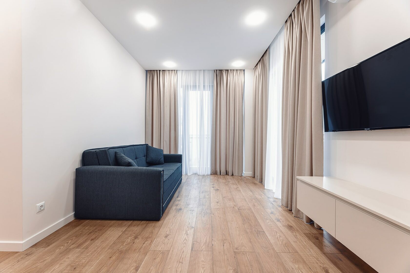 Living area at NEXT Green with sofa and television